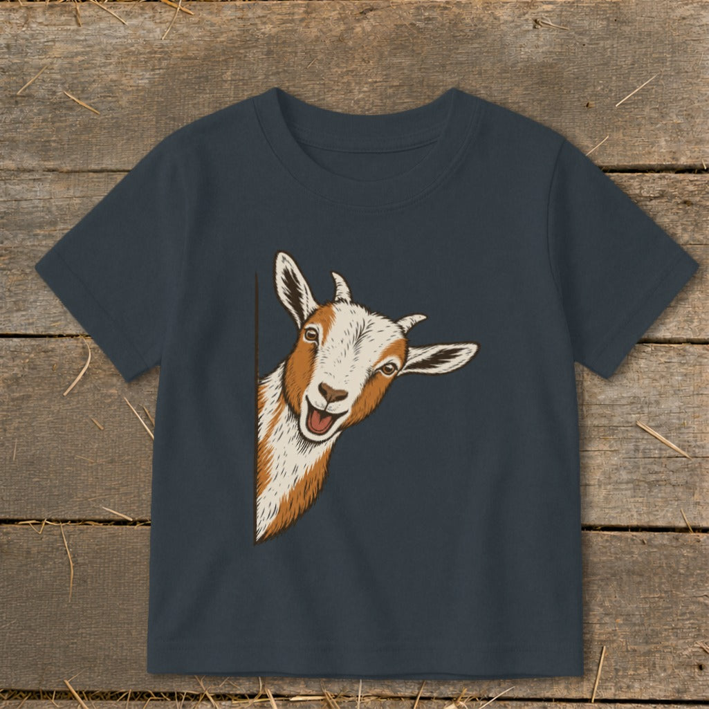 A goat peeks around the side of a navy blue t-shirt.