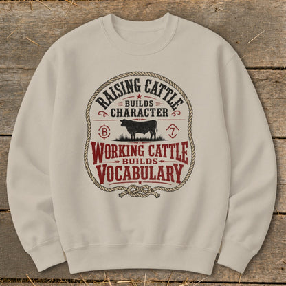 Cream sweatshirt with "Raising Cattle Builds Character, Working Cattle Builds Vocabulary" text and cow graphic.