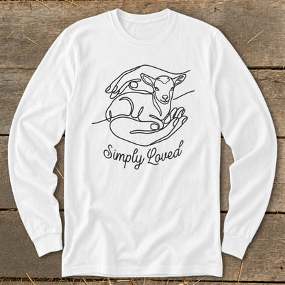 White long-sleeve shirt with "Simply Loved" text and a line drawing of a lamb cradled in hands.