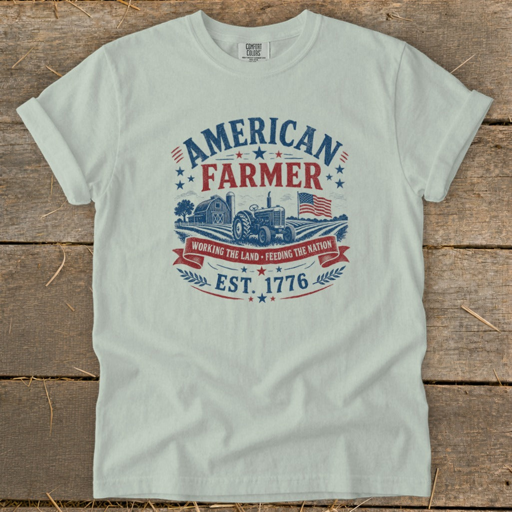 T-shirt graphic with "American Farmer" text, tractor, barn, and flag.
