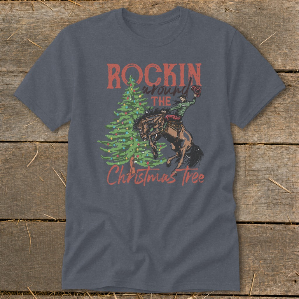 Gray t-shirt with "Rockin' Around The Christmas Tree" graphic of a cowboy riding a bucking horse.