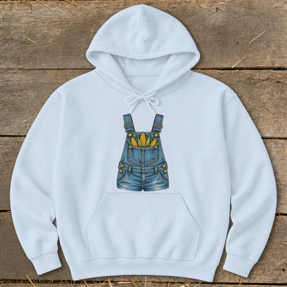 Light blue hoodie with a graphic of denim overalls filled with corn on the cob.