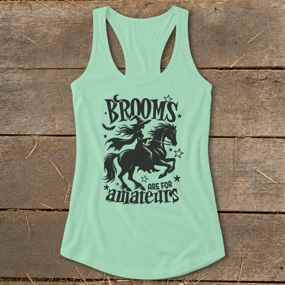 Mint green tank top with black graphic of witch riding a horse, text reads "Brooms are for amateurs".