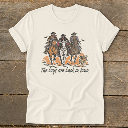 T-shirt with graphic of three skeleton cowboys on horseback, a dog, and text.