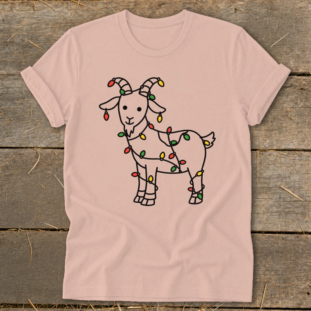 Pink t-shirt with a black line drawing of a goat wrapped in colorful Christmas lights.