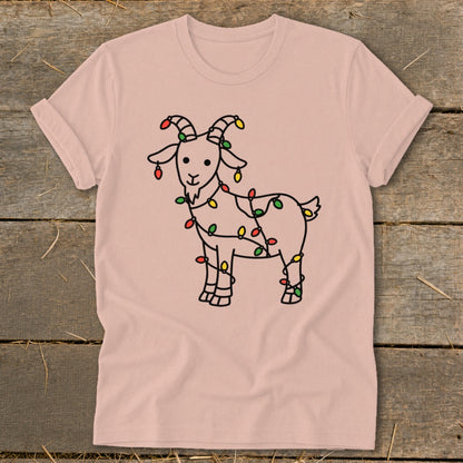 Pink t-shirt with a black line drawing of a goat wrapped in colorful Christmas lights.