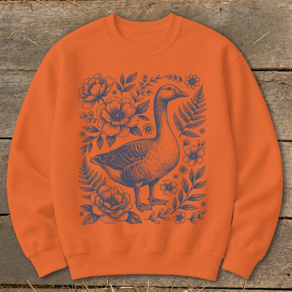 Orange sweatshirt with a blue goose and floral botanical design.