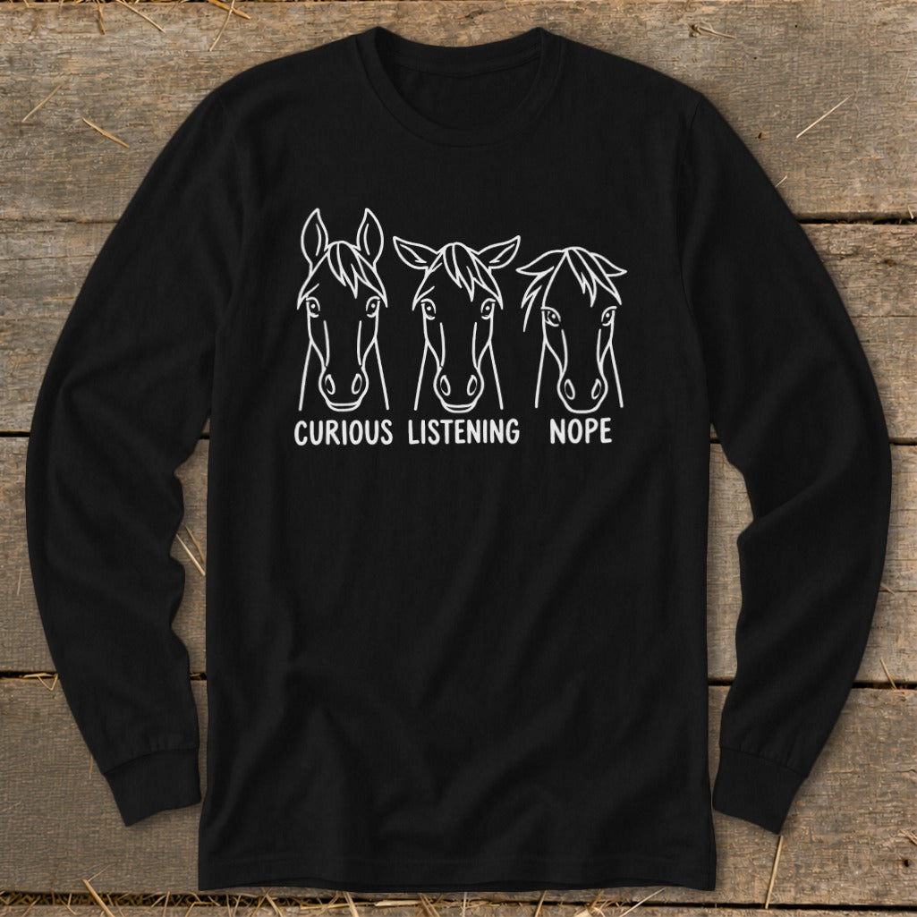 Black long-sleeve t-shirt with a white graphic of three horse heads labeled Curious, Listening, and Nope.