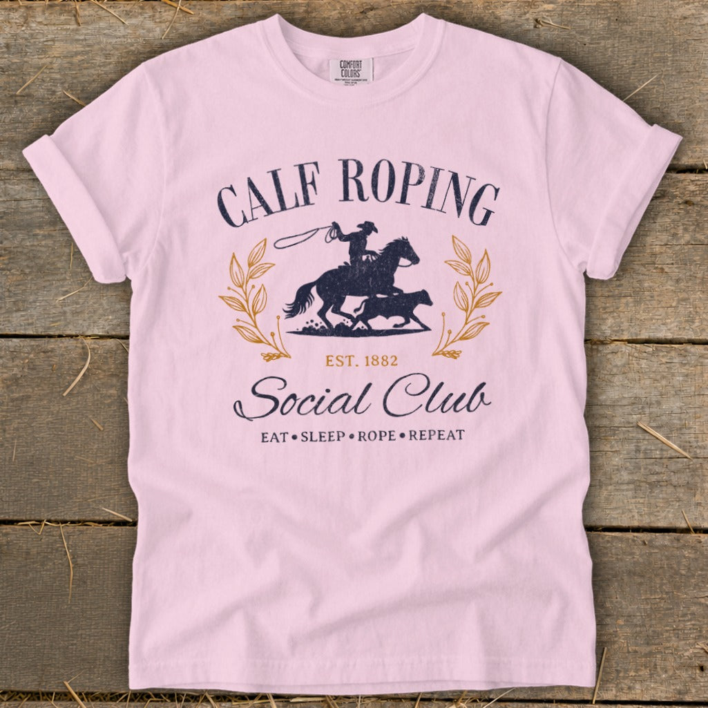 Pink t-shirt with Calf Roping Social Club graphic, featuring a rider, horse, and calf.