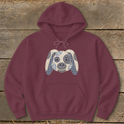 Maroon hoodie with a patchwork dog face applique on the front.