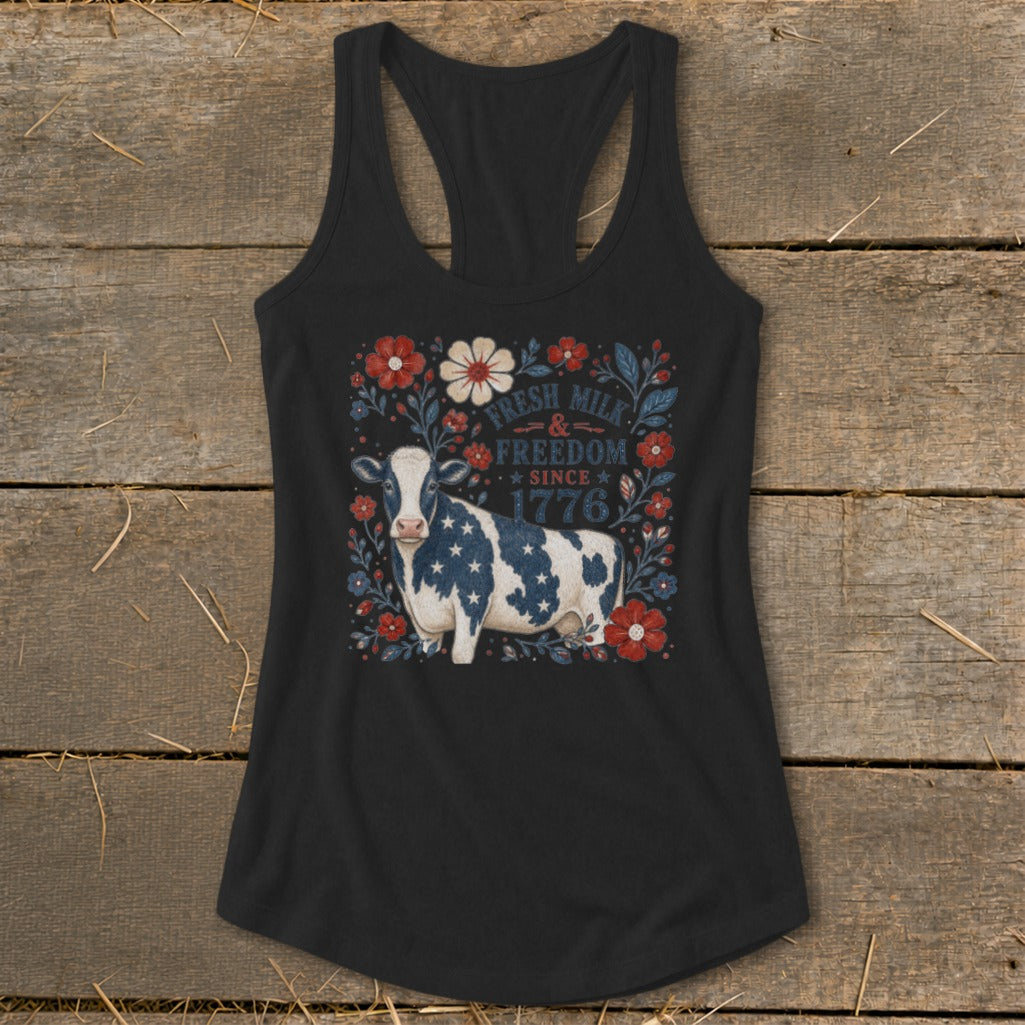 Black tank top with a cow graphic and patriotic text "Fresh Milk & Freedom Since 1776".