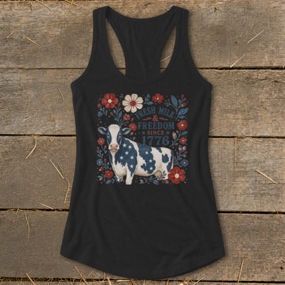 Black tank top with a cow graphic and patriotic text "Fresh Milk & Freedom Since 1776".