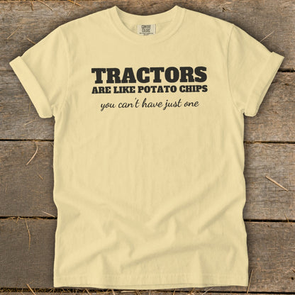 Yellow t-shirt with black text reading "TRACTORS ARE LIKE POTATO CHIPS you can't have just one".