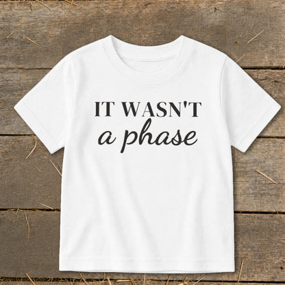 White t-shirt with black text that reads "IT WASN'T a phase".