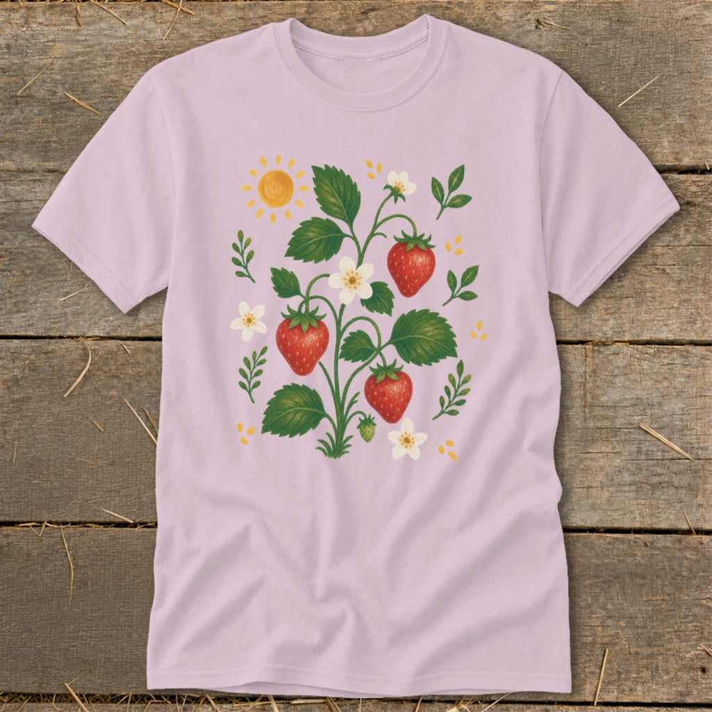 Pink t-shirt with a whimsical strawberry plant and sun graphic.