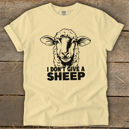 Yellow t-shirt with black print of a sheep and "I DON'T GIVE A SHEEP".
