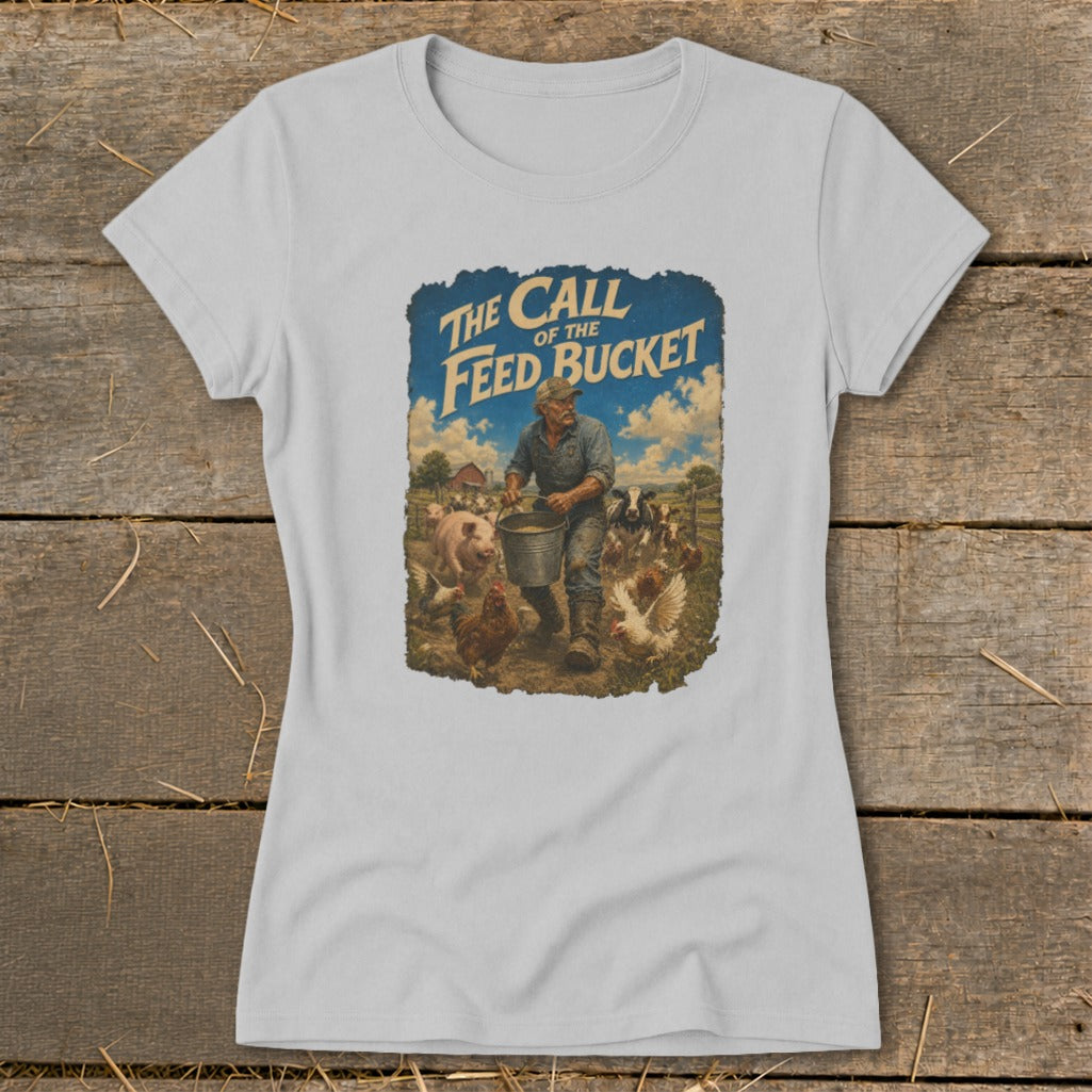 T-shirt graphic: farmer feeding livestock, text "The Call of the Feed Bucket".