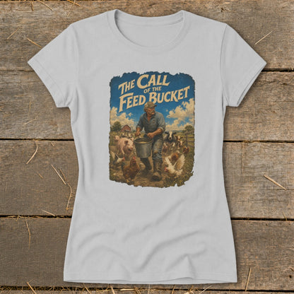 T-shirt graphic: farmer feeding livestock, text "The Call of the Feed Bucket".