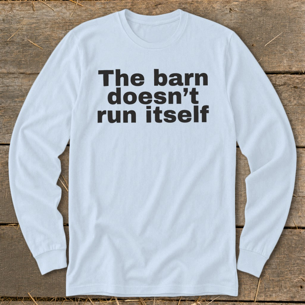 Light blue long sleeve shirt with black text reading "The barn doesn't run itself".