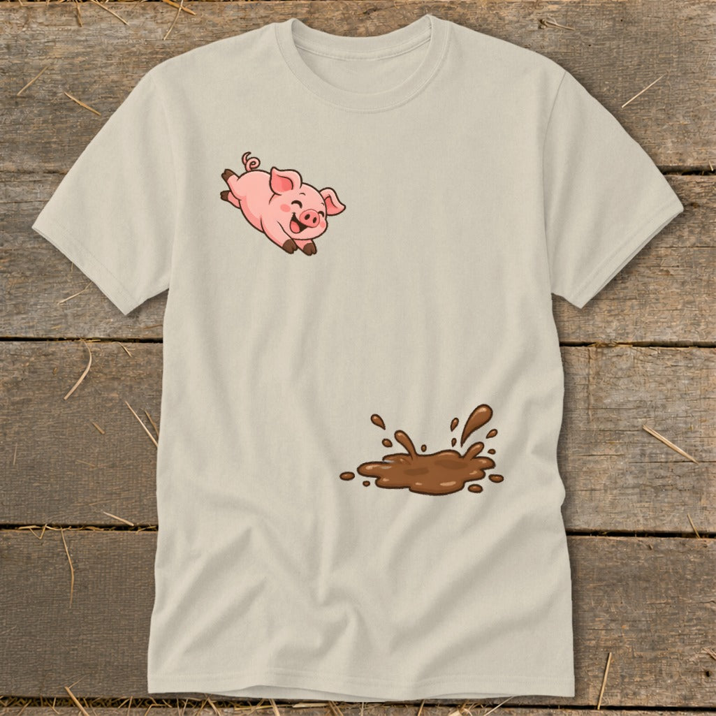 Light tan t-shirt with a cartoon pig jumping towards a mud splash.
