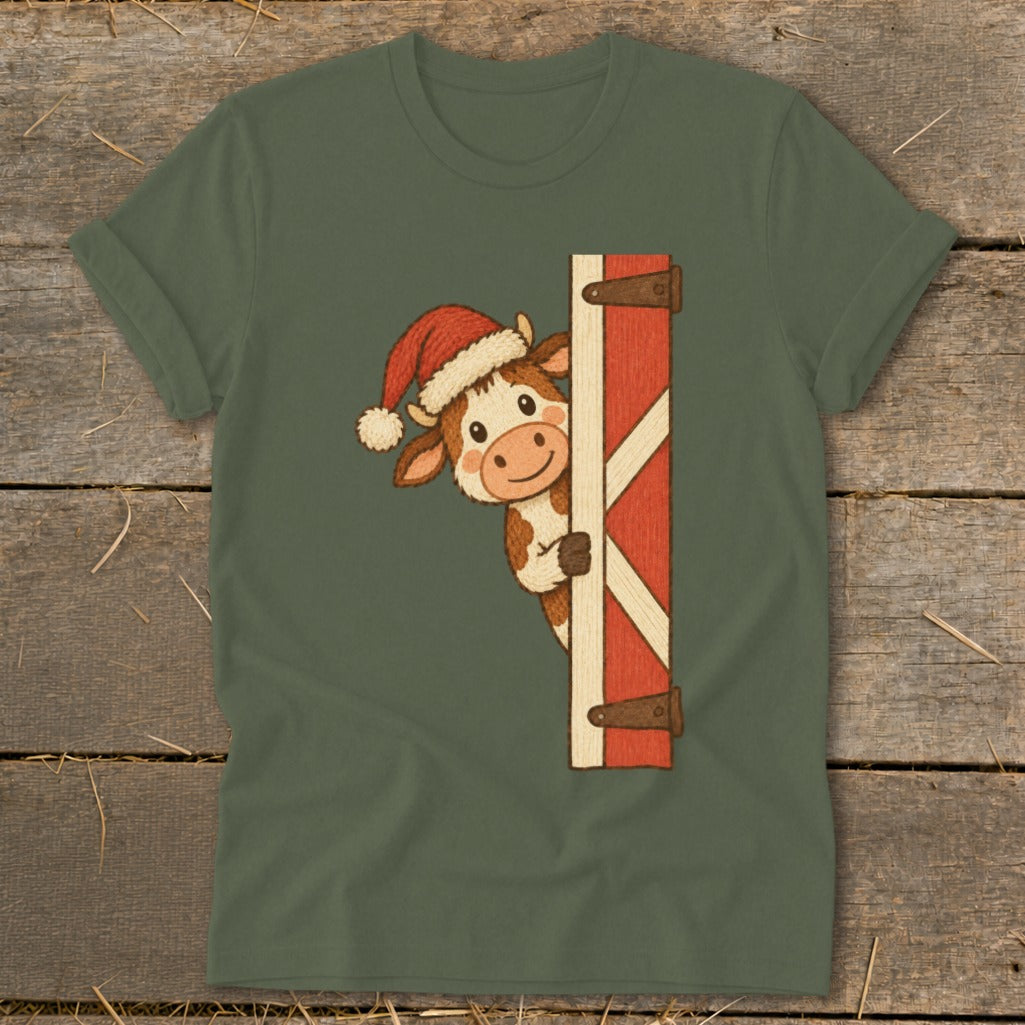 Cartoon cow wearing a Santa hat peeking around a red barn door.