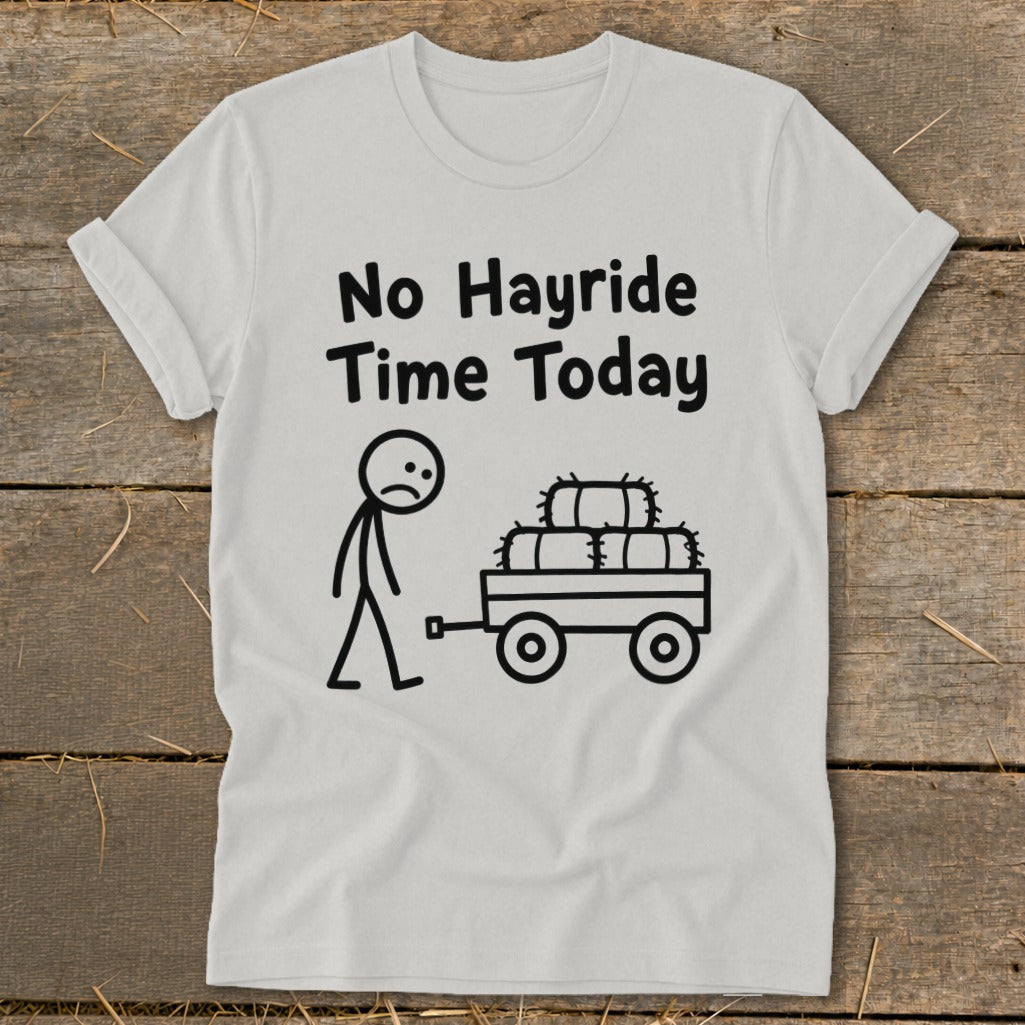 White t-shirt with black text and illustration of a sad stick figure and hay bales on a wagon.
