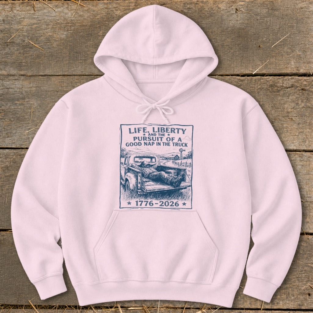 Light pink hoodie with navy graphic: "Life, Liberty and the Pursuit of a Good Nap in the Truck."