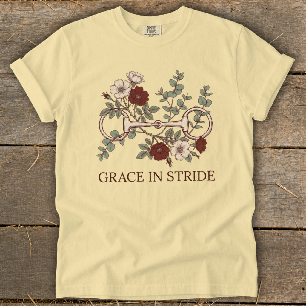 Light yellow t-shirt with horse bit and floral graphic; "GRACE IN STRIDE" text.