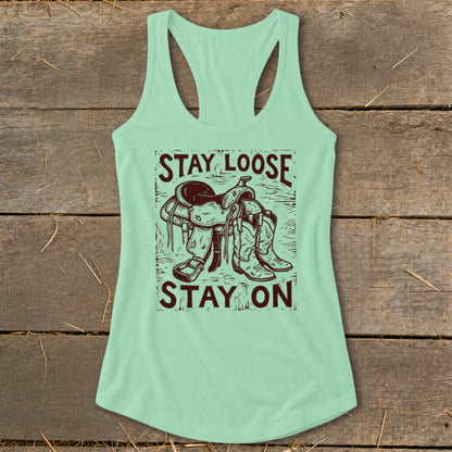 Mint green tank top with "STAY LOOSE STAY ON" text and cowboy saddle and boots graphic.
