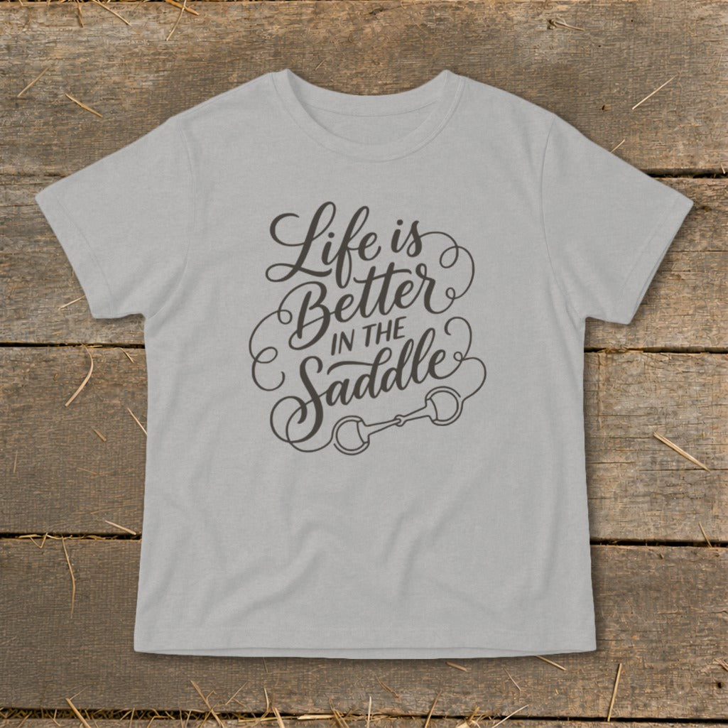 Light gray t-shirt with "Life is Better in the Saddle" text and horse bit graphic.