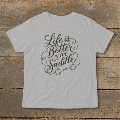 Light gray t-shirt with "Life is Better in the Saddle" text and horse bit graphic.