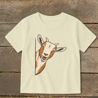 T-shirt with a drawing of a smiling, peeking goat with brown and white markings.