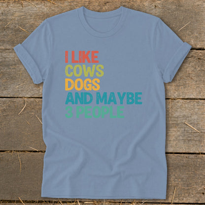 Blue t-shirt with "I like cows dogs and maybe 3 people" text.