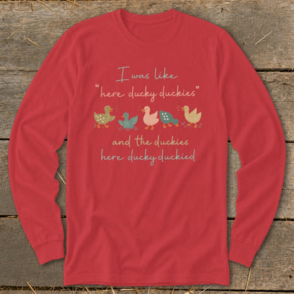 Red long-sleeve shirt with text and cartoon ducks: "I was like 'here ducky duckies' and the duckies here ducky duckied"