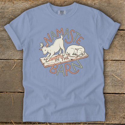 Light blue t-shirt with a "Namaste in the Barn" graphic featuring goats and sheep.