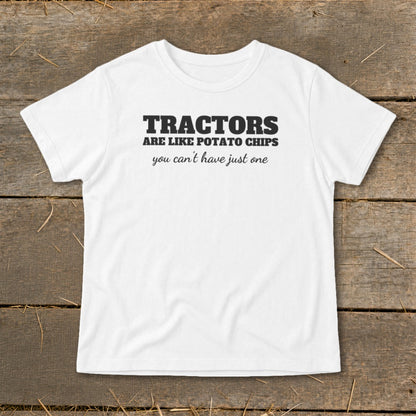 White t-shirt with black text "TRACTORS ARE LIKE POTATO CHIPS you can't have just one".