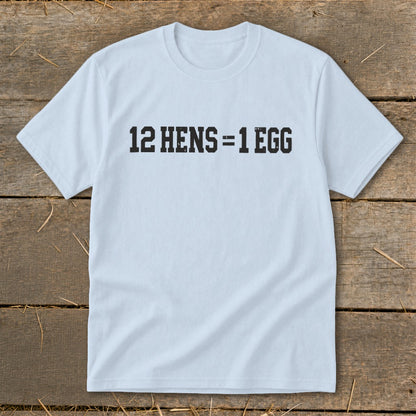 A light blue short-sleeved t-shirt featuring the text 12 HENS = 1 EGG printed on the chest.
