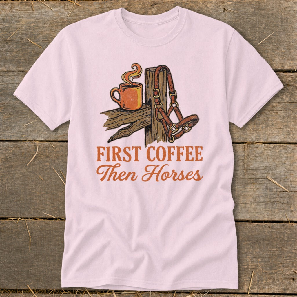 Pink t-shirt with graphic of coffee cup, horse halter, and text "First Coffee Then Horses".