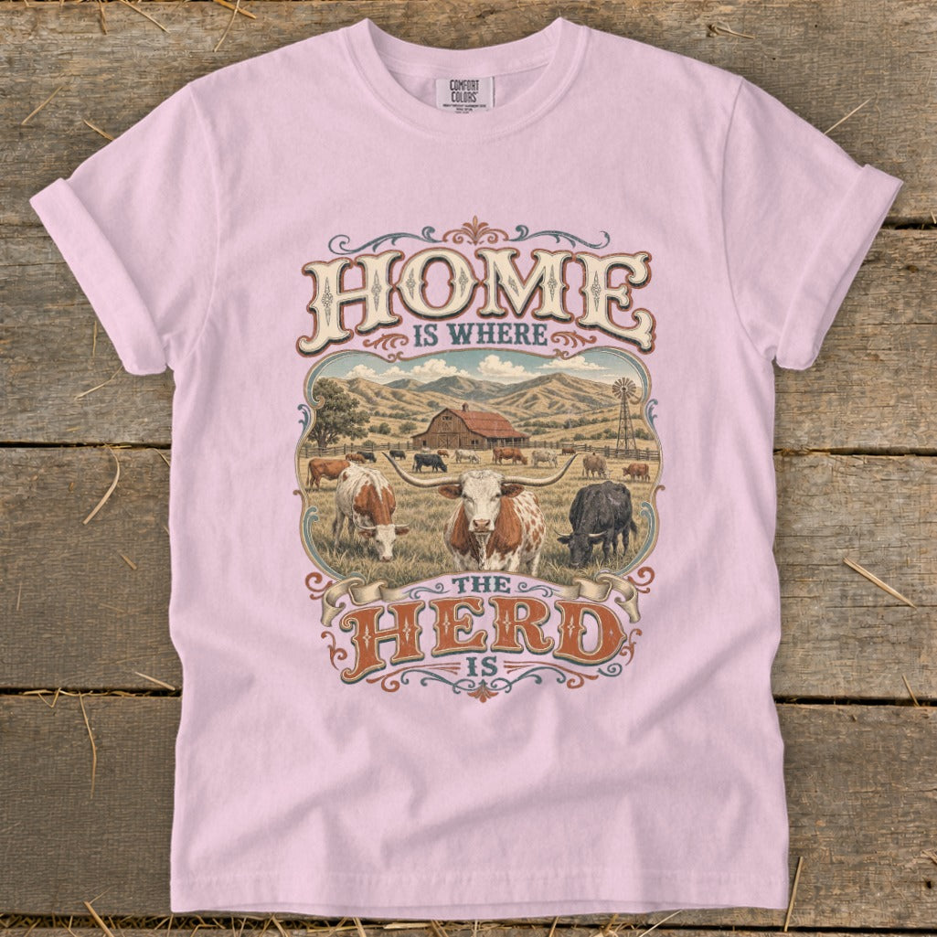 Pink t-shirt with "HOME IS WHERE THE HERD IS" text and farm scene.