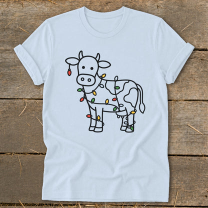 White t-shirt with a black outline of a cow wrapped in colorful Christmas lights.