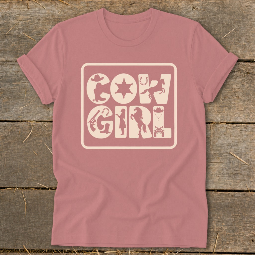 Pink t-shirt with a graphic featuring the words "COW GIRL" surrounded by western-themed icons.