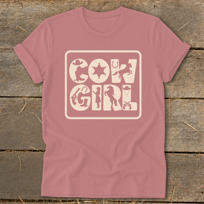 Pink t-shirt with a graphic featuring the words "COW GIRL" surrounded by western-themed icons.