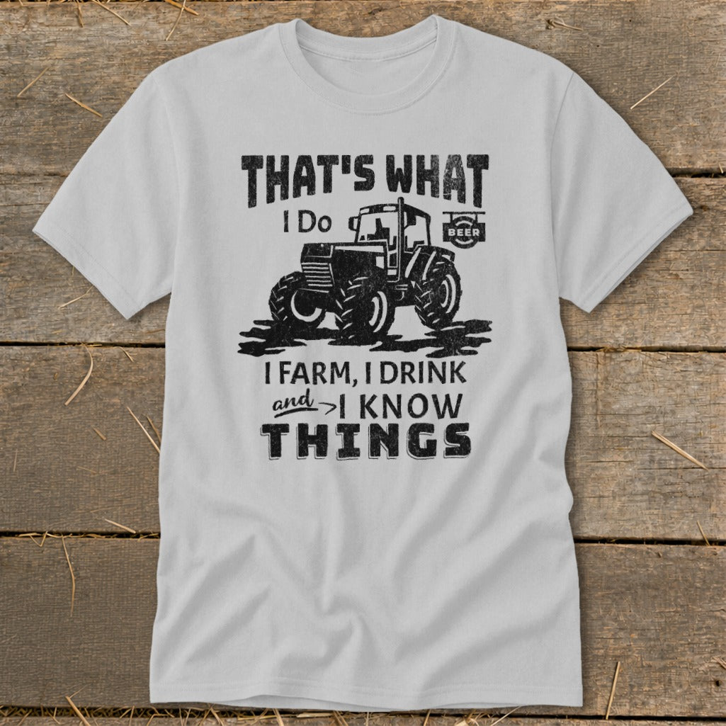 Grey t-shirt with "That's What I Do: I Farm, I Drink, and I Know Things" text and tractor graphic.