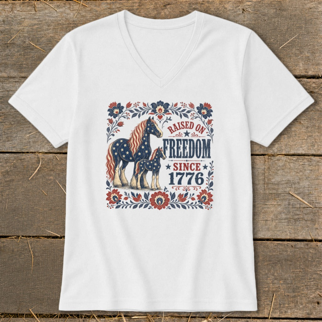 White t-shirt with patriotic horses and "Raised on Freedom Since 1776" text.
