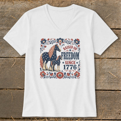 White t-shirt with patriotic horses and "Raised on Freedom Since 1776" text.