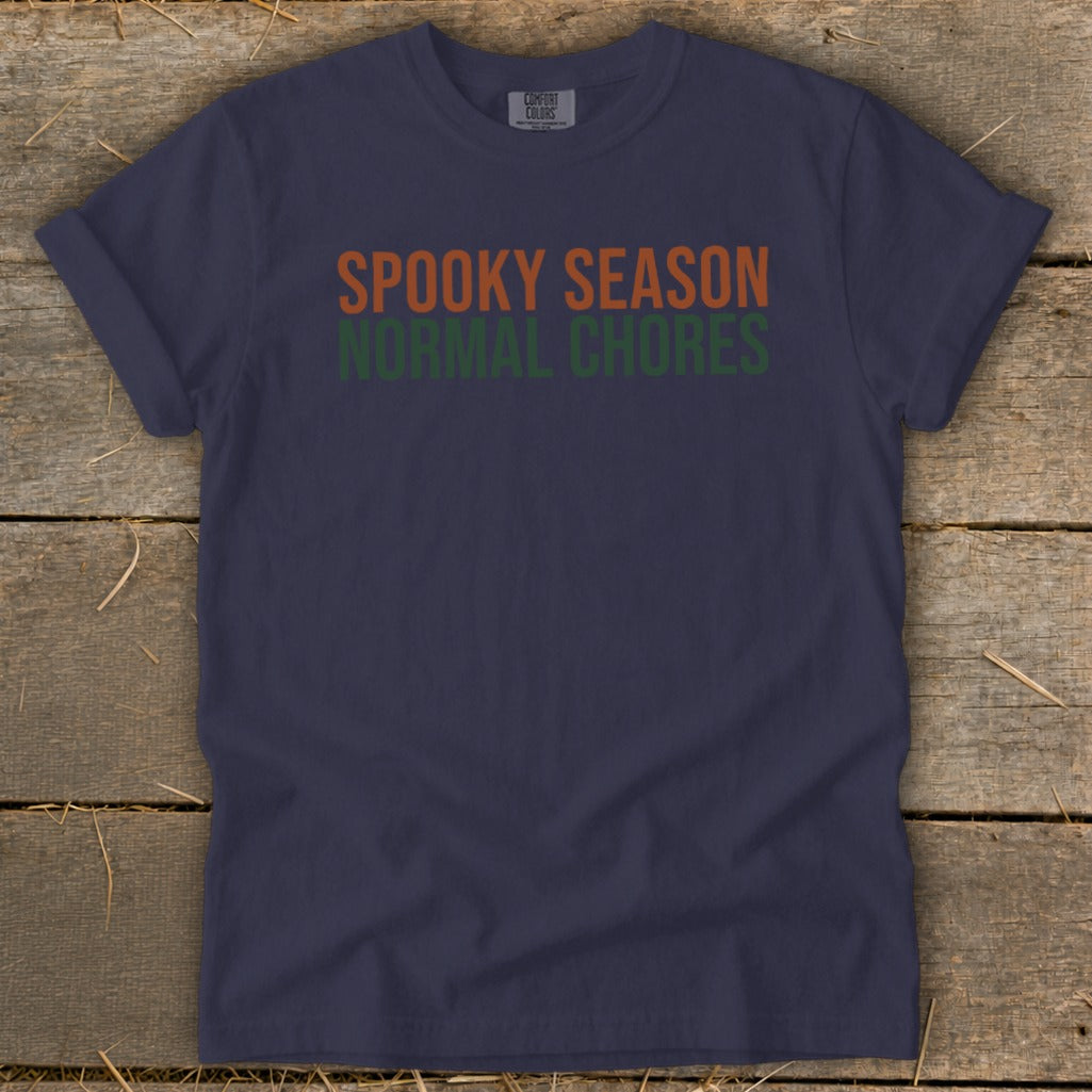 Navy t-shirt with "SPOOKY SEASON" in orange and "NORMAL CHORES" in green.