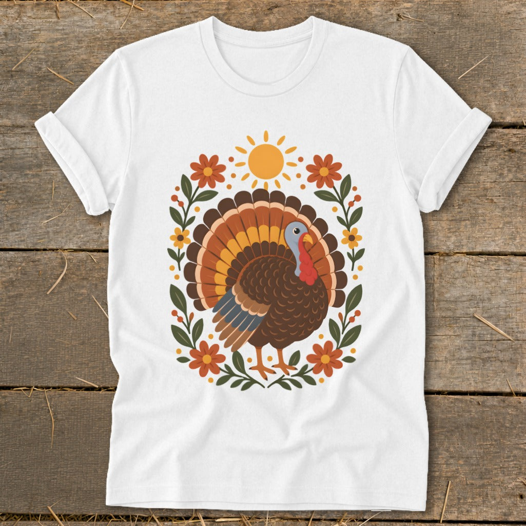 White t-shirt with colorful cartoon turkey and floral sun graphic.