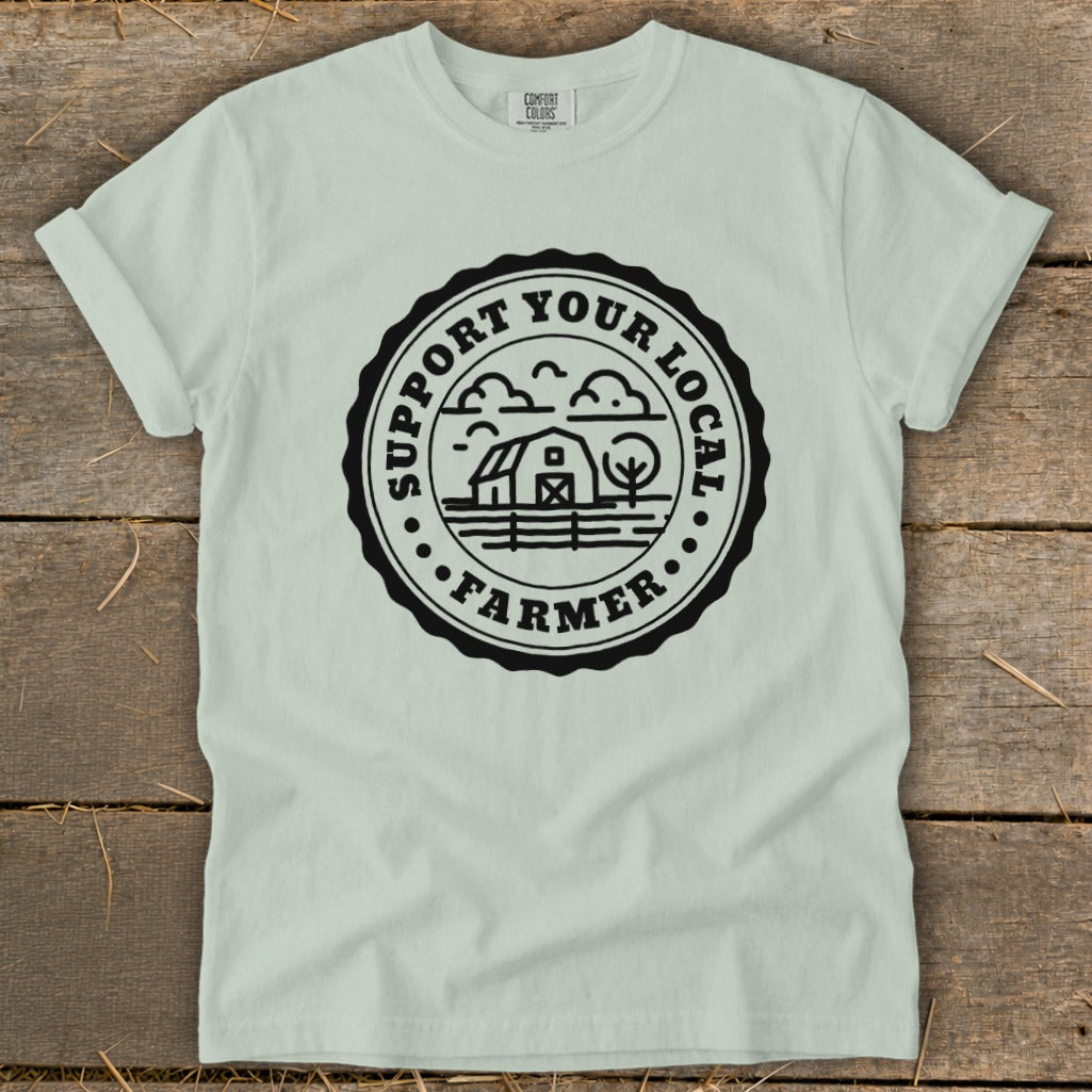 Light green t-shirt with black circular "Support Your Local Farmer" graphic.