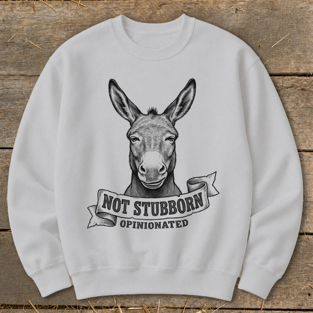 White sweatshirt with a donkey's head graphic and text "NOT STUBBORN OPINIONATED".