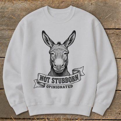 White sweatshirt with a donkey's head graphic and text "NOT STUBBORN OPINIONATED".